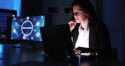Mature trader woman working inside hedge fund office doing blockchain research