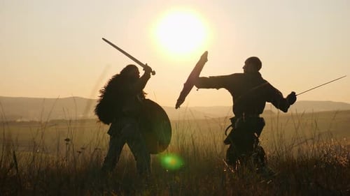 Silhouetted Warriors Sword Fight at Sunset