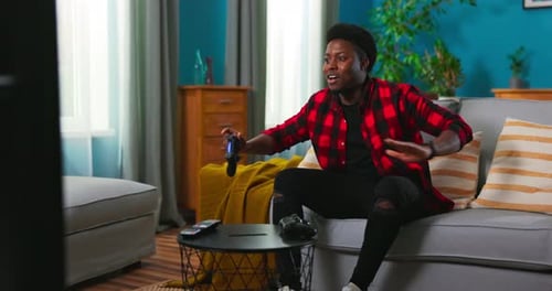 Man Relaxing on Couch Playing Video Game