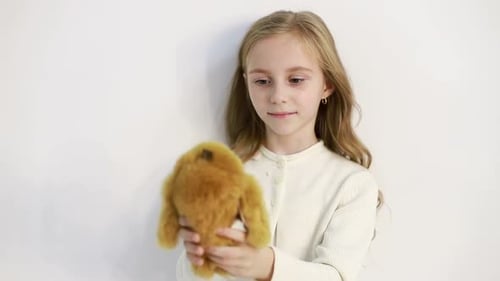 Young Girl Hugging Stuffed Rabbit