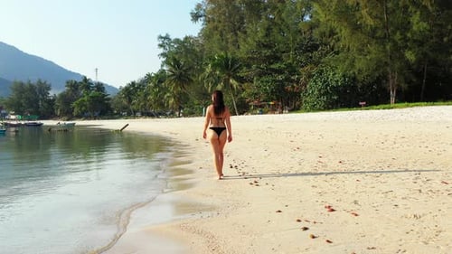 Beautiful beauty models relaxing in the sun at the beach on clean white sand and blue background 4K