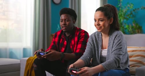 Couple Relaxing at Home Playing Video Games