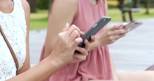 Young Adults Using Mobile Phones Outdoors