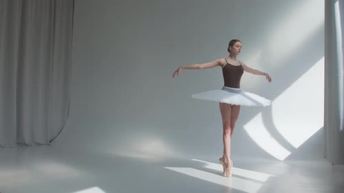 Young Woman Dancing Ballet in Studio