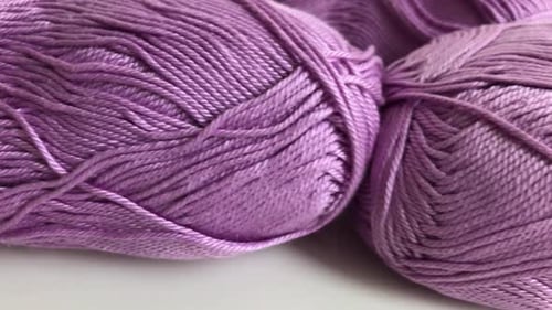Shallow DOF skeins of knitting wool dolly 4K 2160p 30fps UltraHD footage - Pink yarn of wool wrap