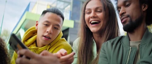 Group of Friends Looking at Smartphone Together