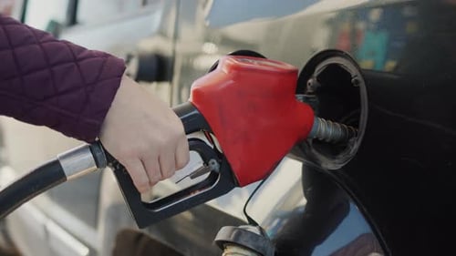 The Driver Fills His Car with Liquid Fuel
