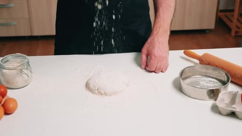 Baker Prepares Dough for Baking in the Kitchen