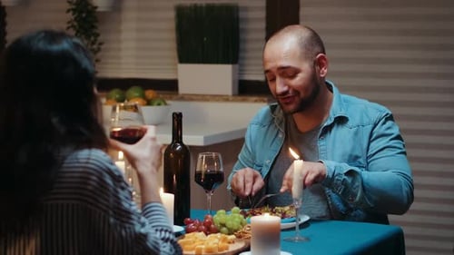 Couple Sharing Romantic Candlelit Dinner at Home