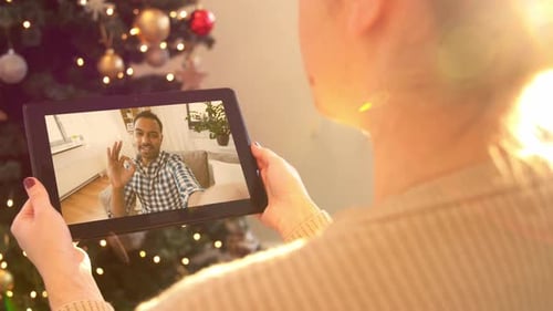 Woman Video Calling with Man During Christmas Time