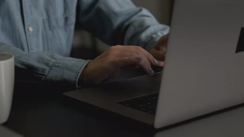 Close-Up of a Woman's Hand Using a Laptop, Browsing Information and Social Networks