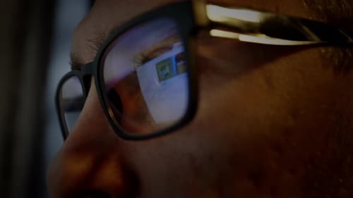 Close Up of Person Wearing Glasses Looking at Screen