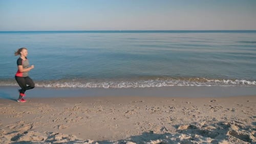 Woman Runs on Sea Beach