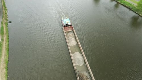 Aerial View of Large Cargo Barge Moving Along the River