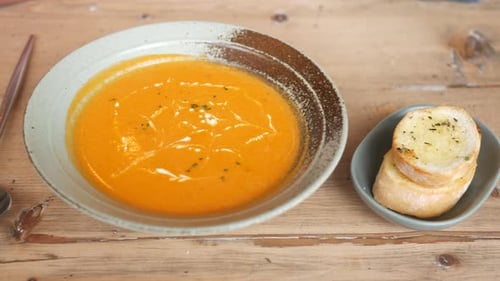Bowl of Delicious Soup with Bread on Table