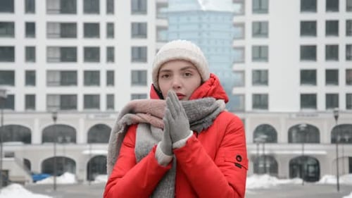 Portrait of a Girl in a Red Jacket in the City Against the Background of Modern Buildings During