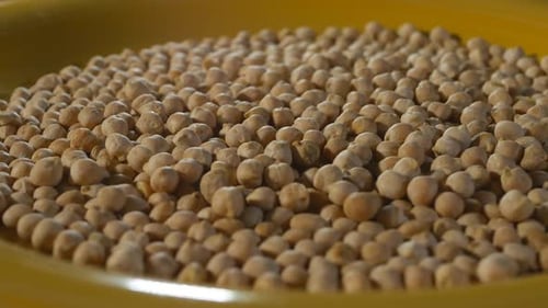 Pile of Dry Chickpeas in a Yellow Bowl