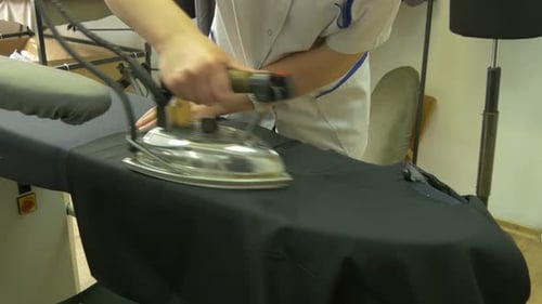Woman's hands ironing