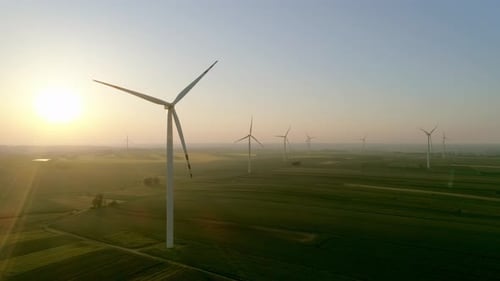 Drone view of wind turbines at sunset