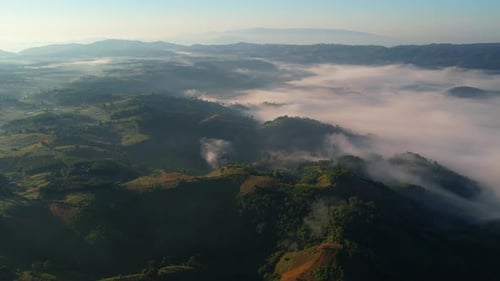 Aerial view of sunrise with fog above mountains