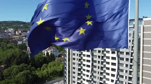 European Union Flag Waves Near Buildings