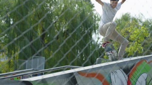 Young Man Skateboarding in Urban Skate Park