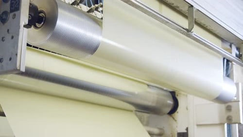 Machine Rolls Sheets of Material