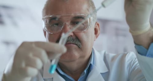 Scientist Working With Pipette and Test Tube
