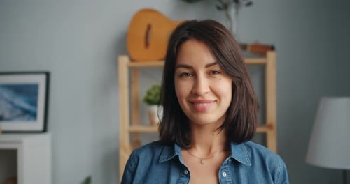 Smiling Woman Looking at Camera in Living Room