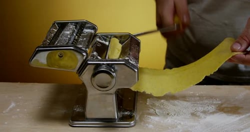 Person Making Fresh Pasta with a Pasta Maker