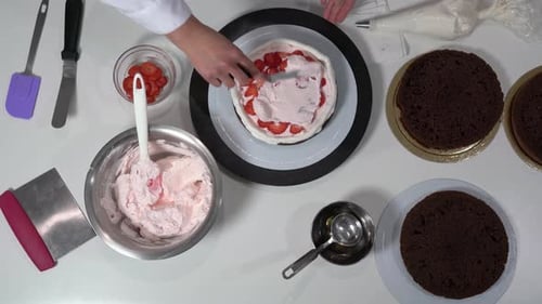 Cake Creation with Strawberries and Pink Frosting