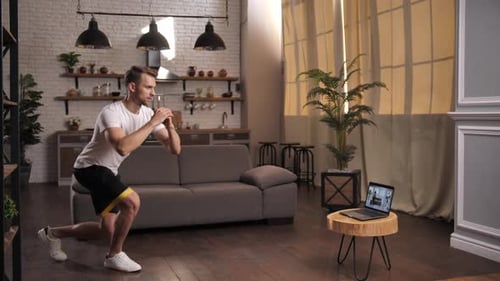 Man Exercising at Home Using Resistance Band