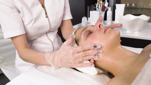 Woman Receiving Relaxing Facial Massage at Spa