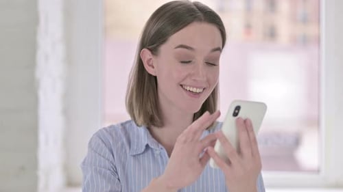 Portrait of Beautiful Young Woman Using Smartphone