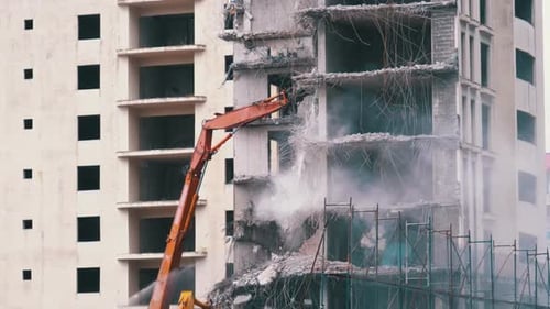 Crane Demolishing an Unfinished Building