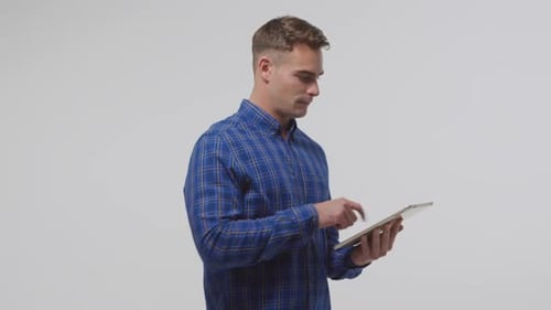 Young Adult Using Tablet Device