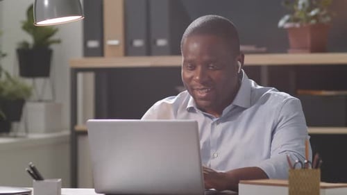 Afro-American Office Worker Video Calling on Laptop