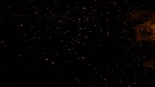 Bright Sparks and Embers on Black Background