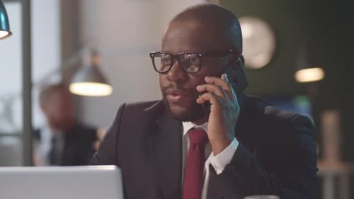 Afro-American Businessman Talking on Phone in Office