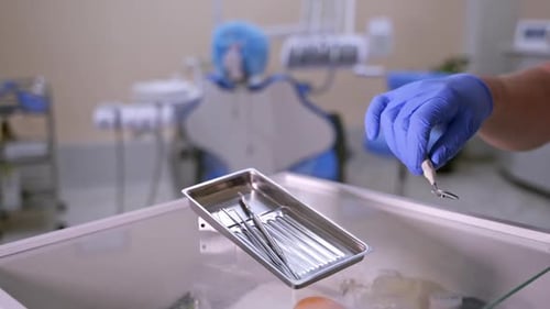 Dentist Selecting Dental Instruments for Treatment