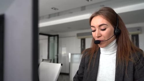 Woman Speaking with Headset in Office Environment