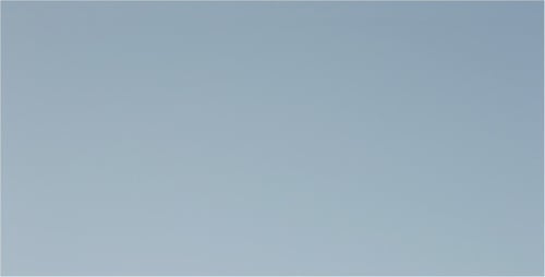 Soap Bubbles Floating Against Blue Background