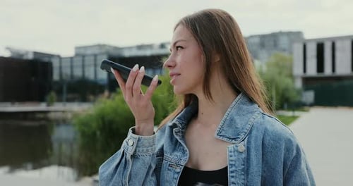 Woman Using Voice Message Feature on Smartphone