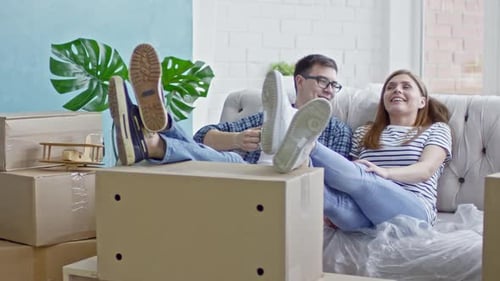 Tired Couple Resting in New Flat