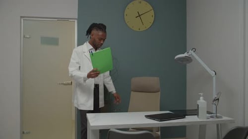 Male Doctor in Office Looks Stressed