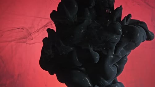 Black Ink Plume Against Red Backdrop