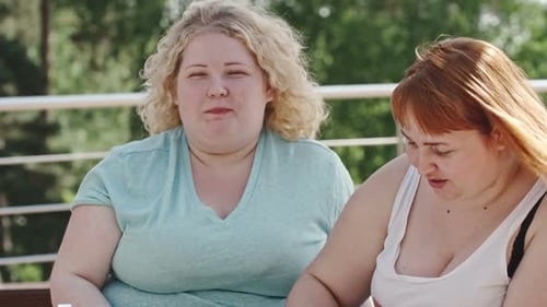 Women Friends Eating Healthy Outdoors in the Sunlight