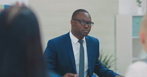 Man Leading Discussion in Bright Modern Office