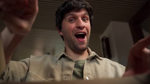 Man Opening Box with a Surprised Expression