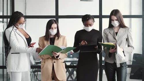 Four Women in Masks Working in Modern Office